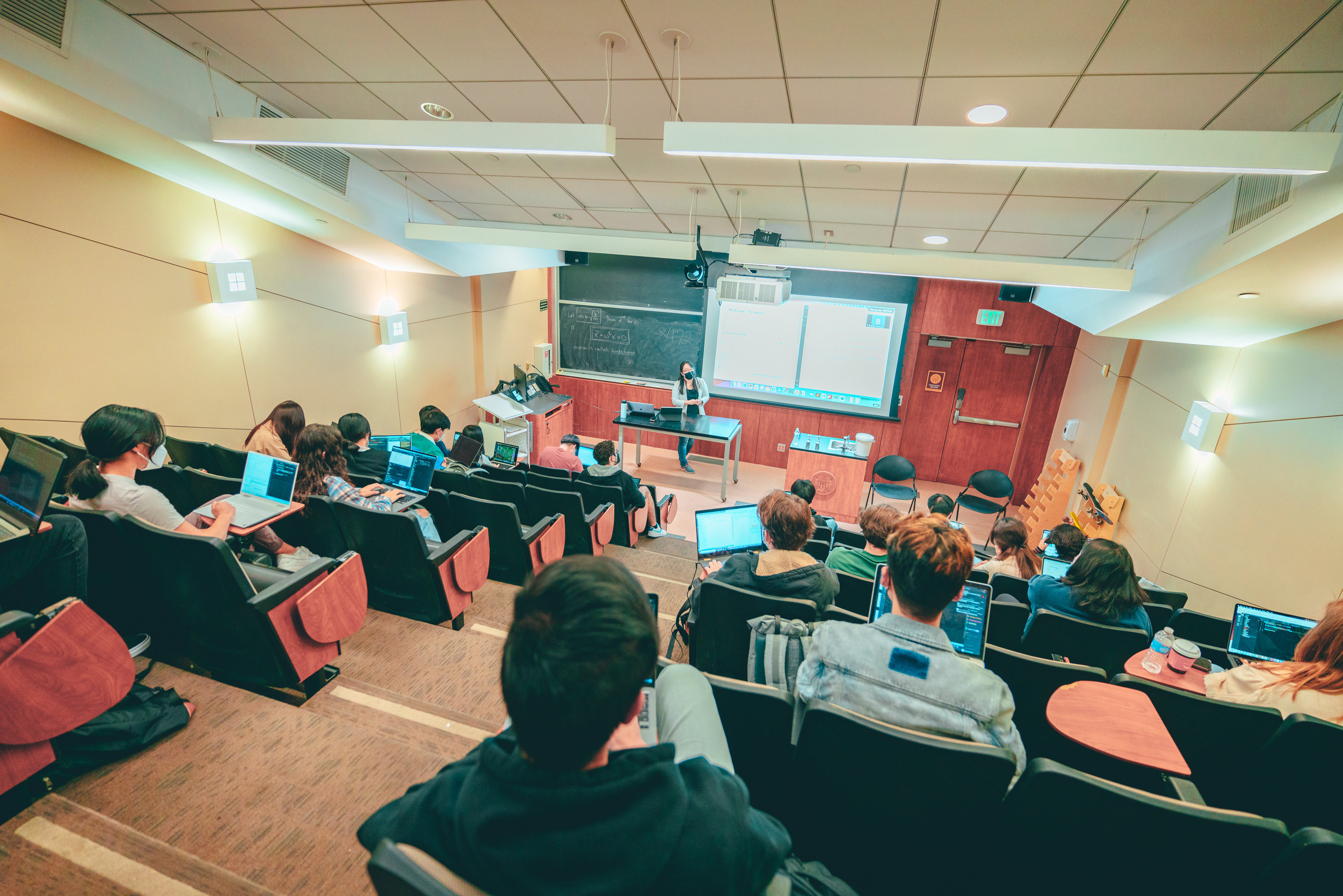 Teaching in front of a classroom full of students.